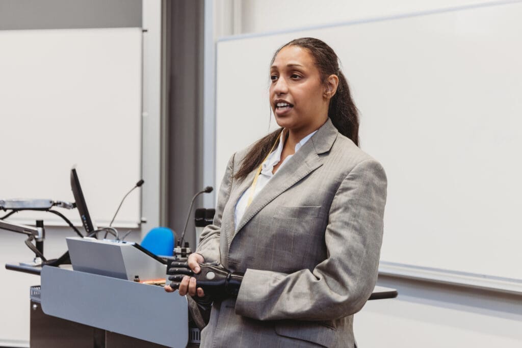 Speaker who wears a bionic arm giving a presentation