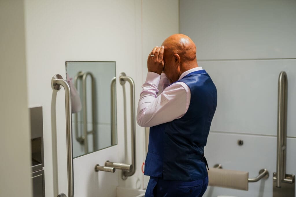 Person with less-visible disability in accessible toilet