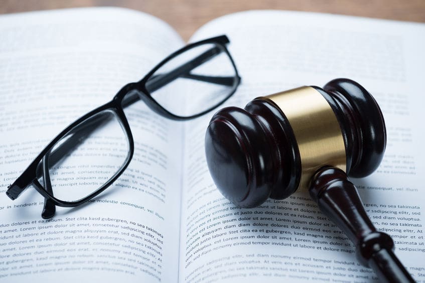 Mallet And Eyeglasses On Open Legal Book Mallet and eyeglasses on open legal book.