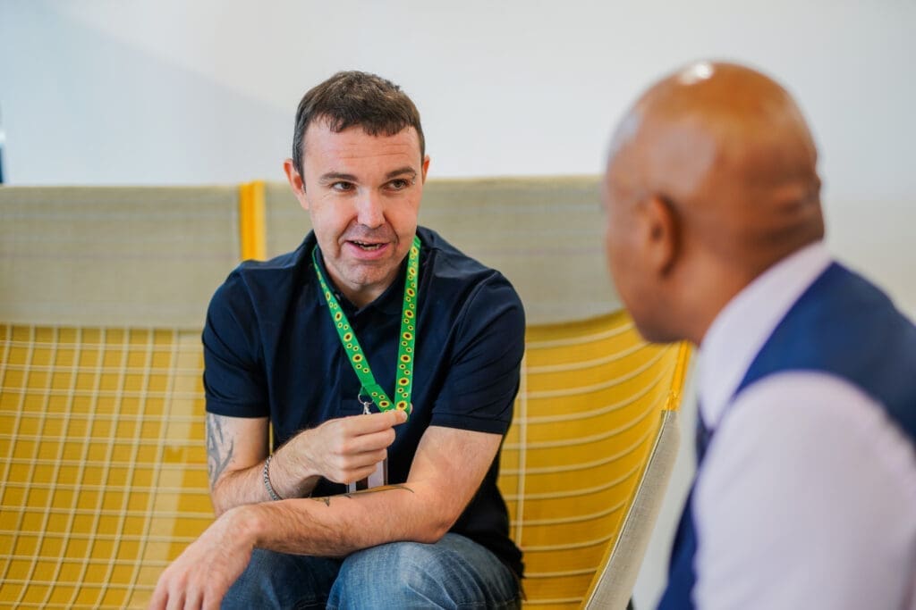 Two colleagues with less-visible disabilities interact.