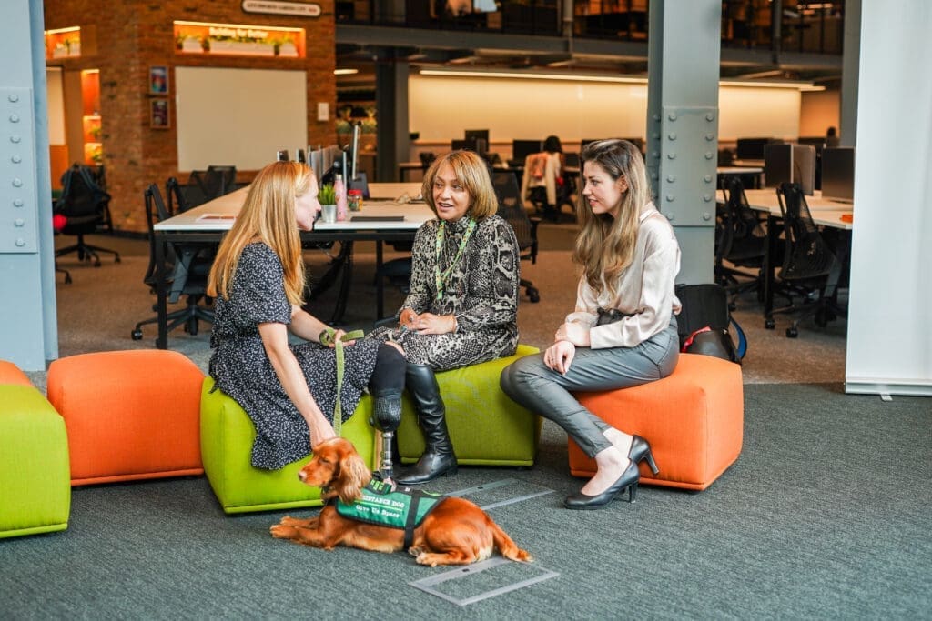 Group of people with diverse disabilities meeting in an office.