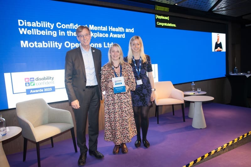 Employees from Motability Operations Ltd. pose with an award at the Disability Confident awards 2023.