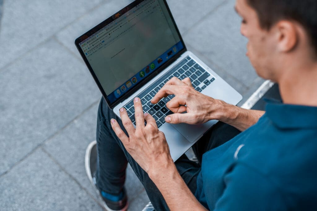 Person with a physical impairment uses a laptop.