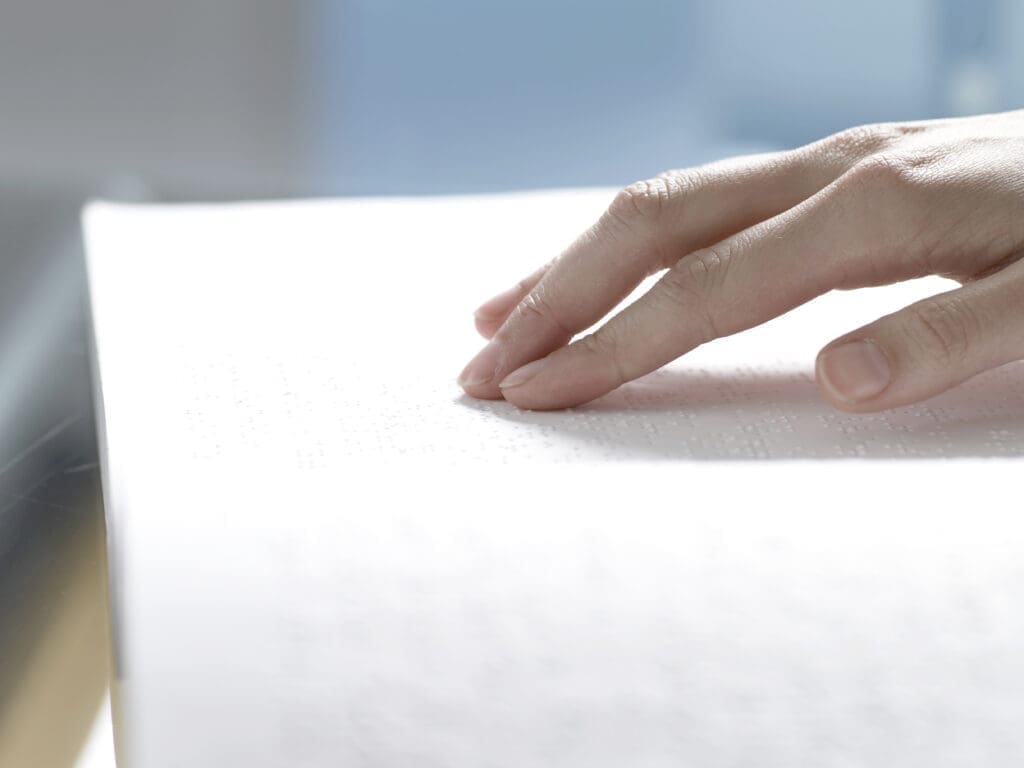 A person reading a braille book