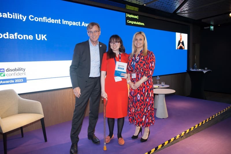 Employees from Vodafone UK pose with an award at the Disability Confident awards 2023.
