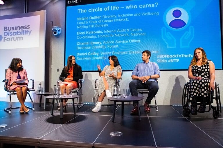 Panel on stage at the NatWest BDF conference. From left to right: Bela Gor (chair), Natalie Quilter, Eleni Katsoulis, Daniel Cady and Chantel Emery.