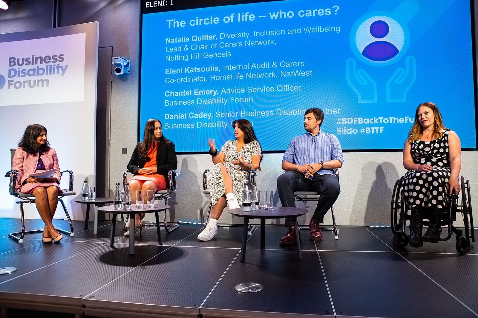 Panel on stage at the NatWest BDF conference. From left to right: Bela Gor (chair), Natalie Quilter, Eleni Katsoulis, Daniel Cady and Chantel Emery.