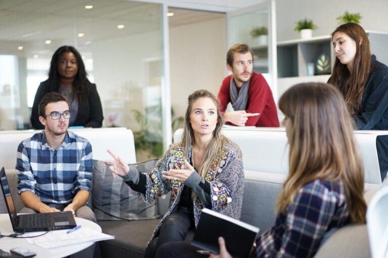 Group of employees all discussing in a meeting