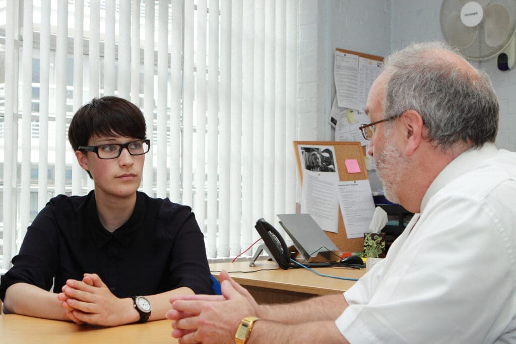 A woman and an older man at a business meeting