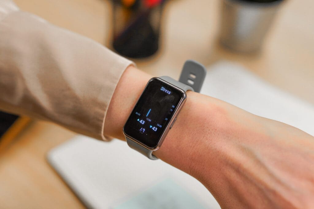 Person checks stress levels on smartwatch in meeting room