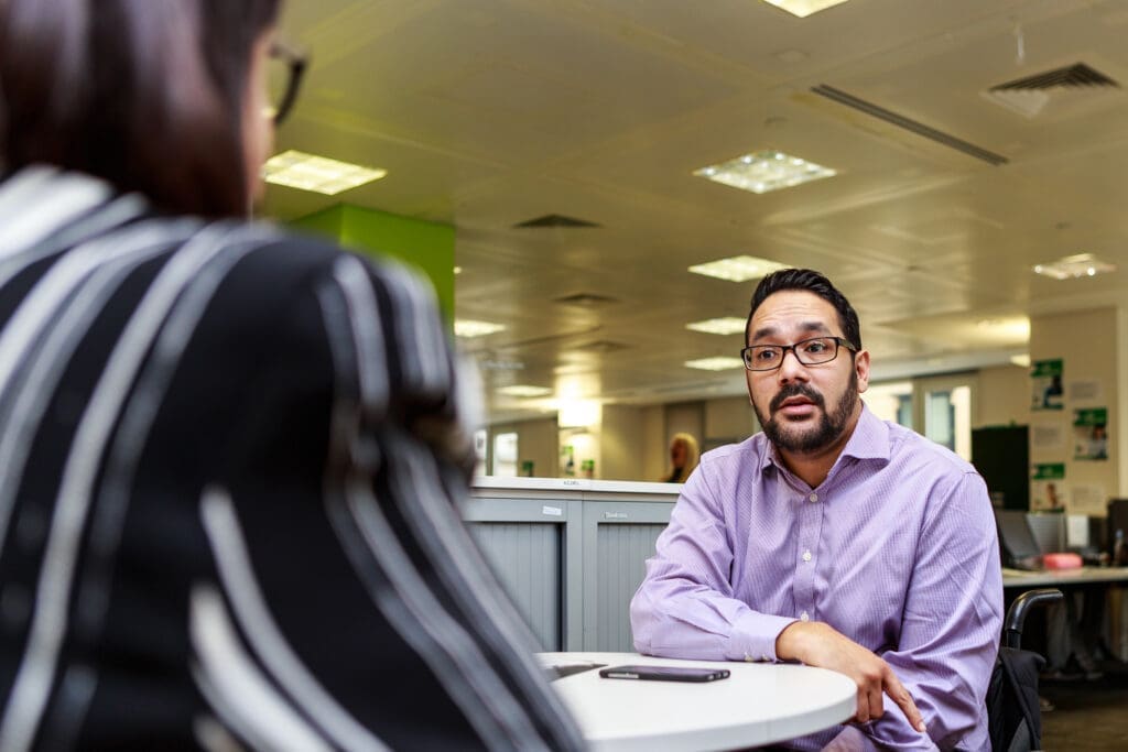 A wheelchair user in a meeting in an office.