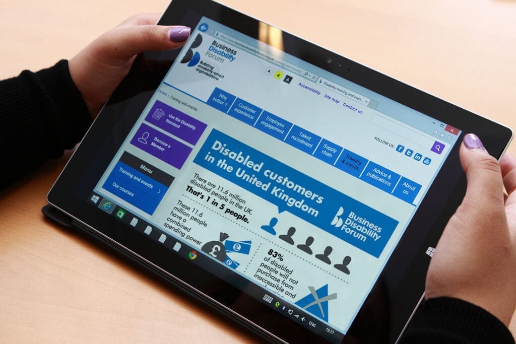 A person using a tablet showing the BDF website