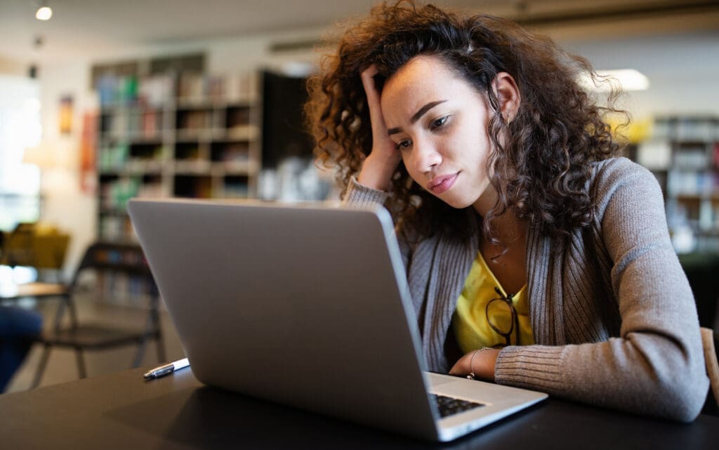 A woman using a laptop in a library