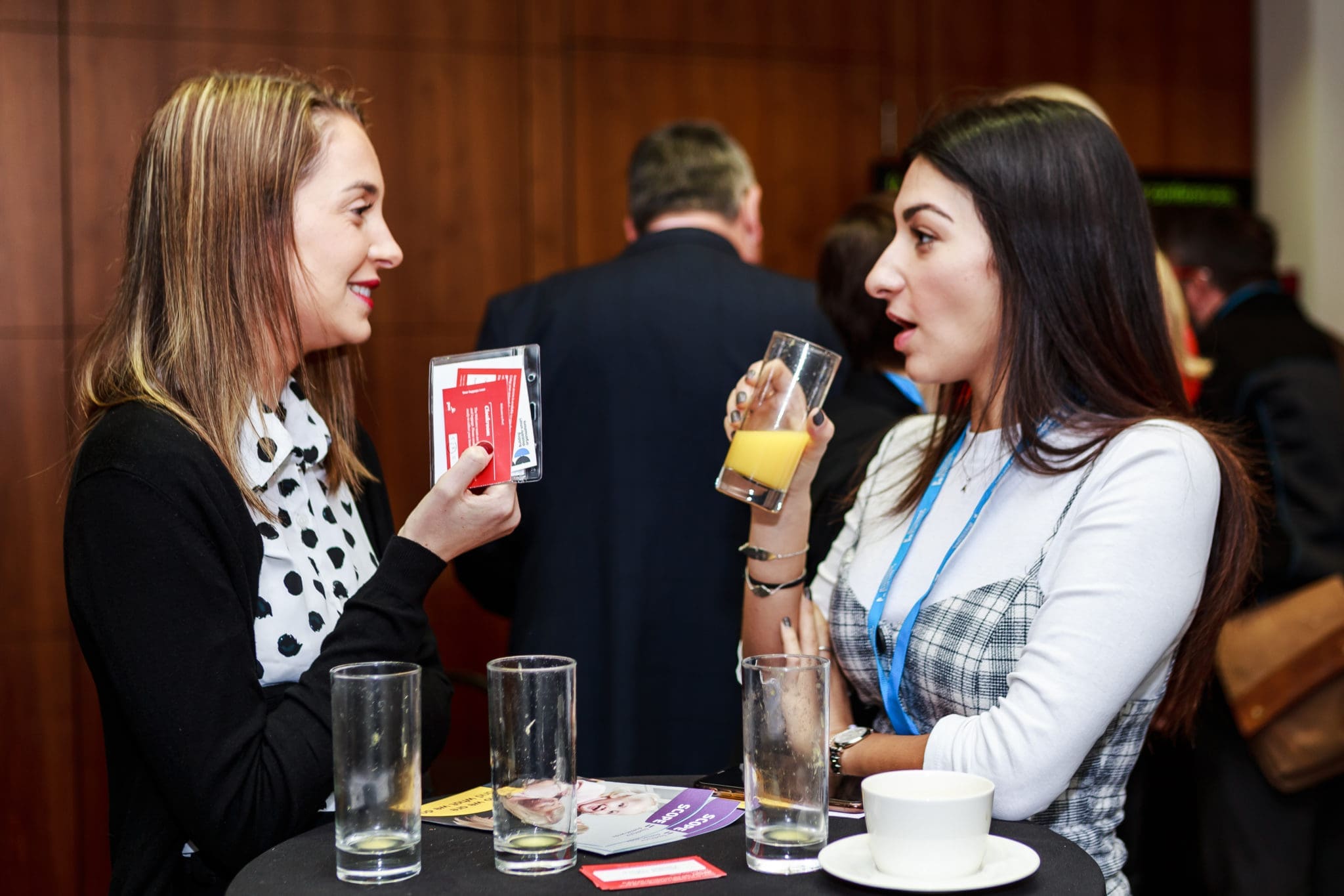 BDF Two women talking at a Business Disability Forum conference.