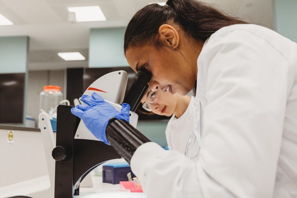 Lab worker using a microscope