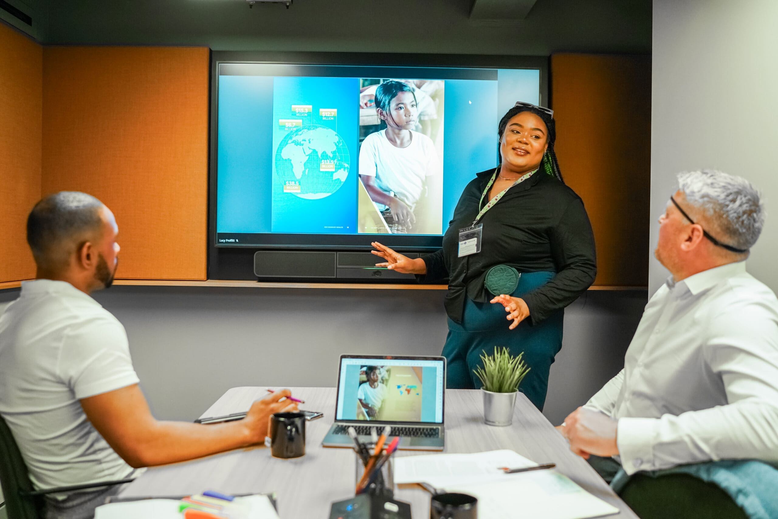 Woman with less-visible disabilities stands to delivers presentation to colleagues