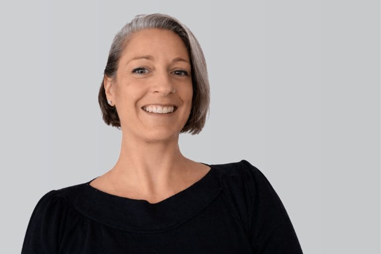 Georgina Wright, Advice Service Manager at Business Disability Forum, smiling against a neutral grey background.