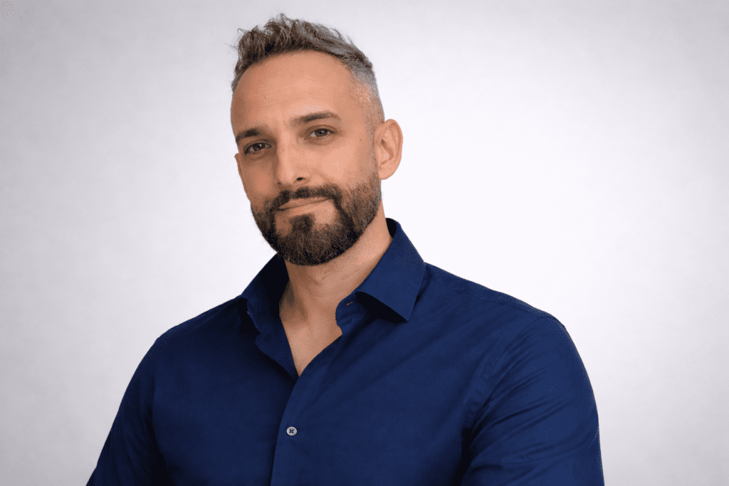 Kier Fox, L&D Business Development Manager at Business Disability Forum, wearing a navy shirt against a neutral background