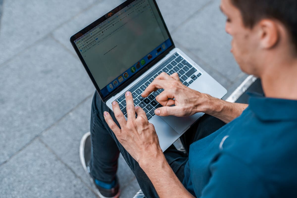 Person with a physical impairment uses a laptop.