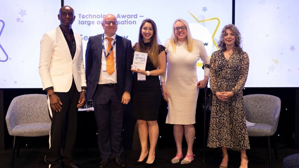 ServiceNow team receiving Technology Award for large organisation on stage at the Disability Smart Impact Awards 2026.