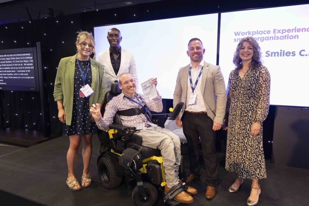 The Happy Smiles C.I.C team receiving their award from ceremony co-hosts John McCalla-Leacy (centre, in white) and Diane Lightfoot (right)