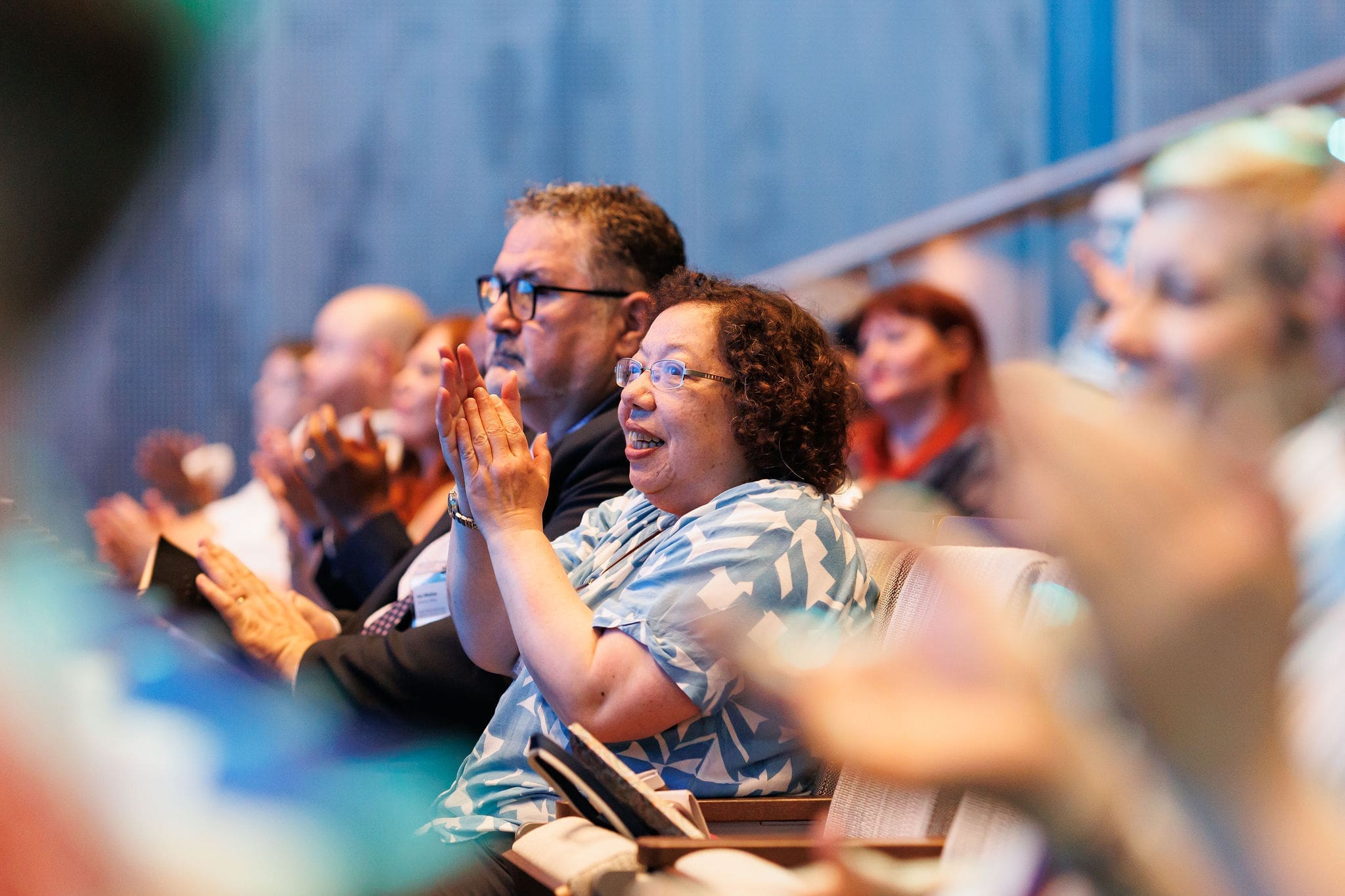 Audience applauding at business conference”